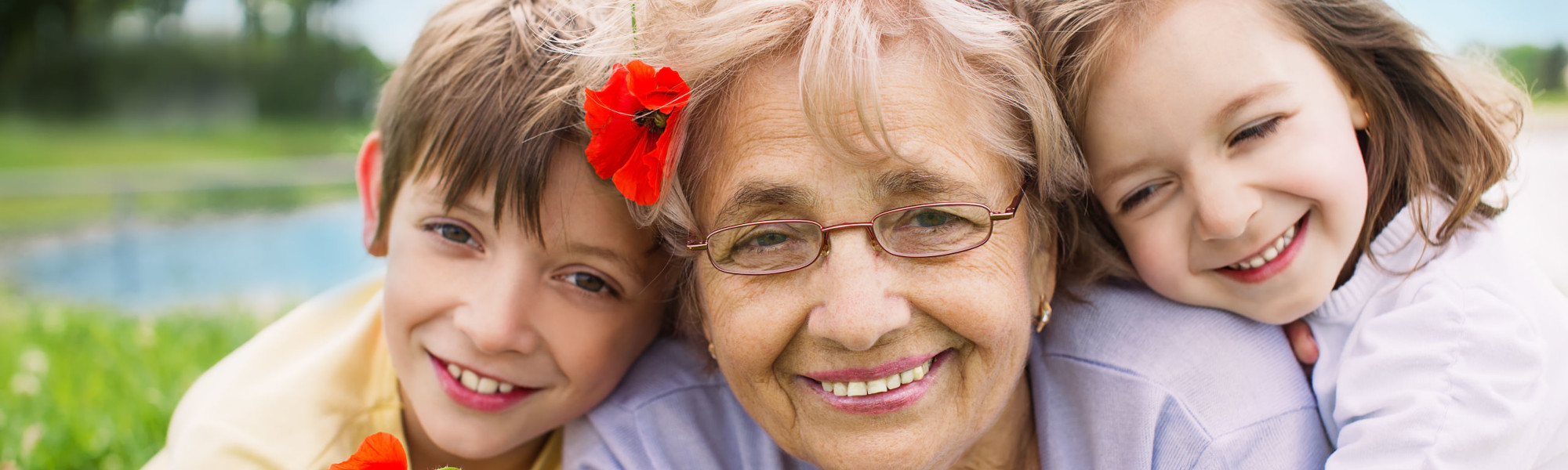 Closeup summer portrait of happy grandmother with grandchildren outdoors